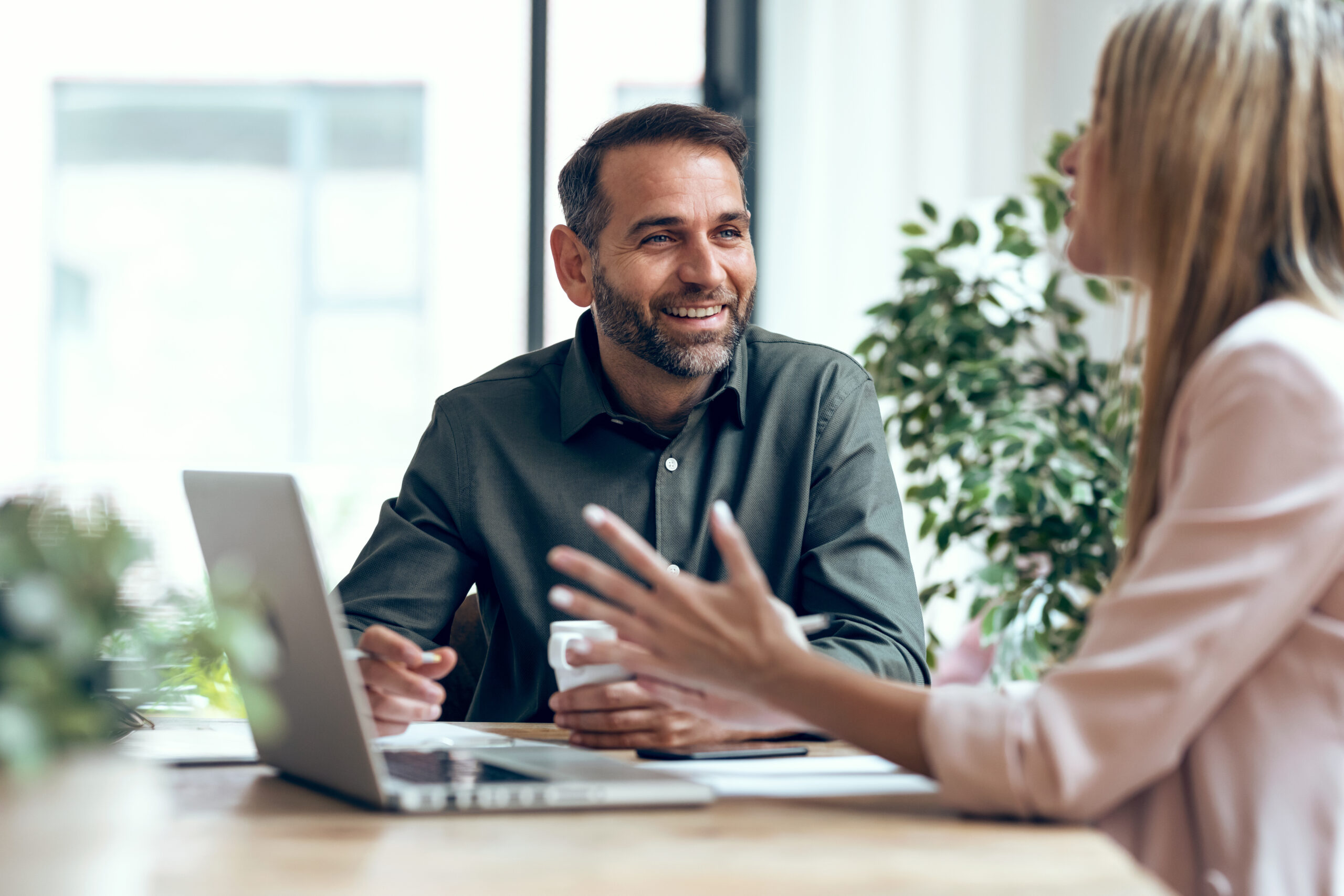 People working together at laptop while talking