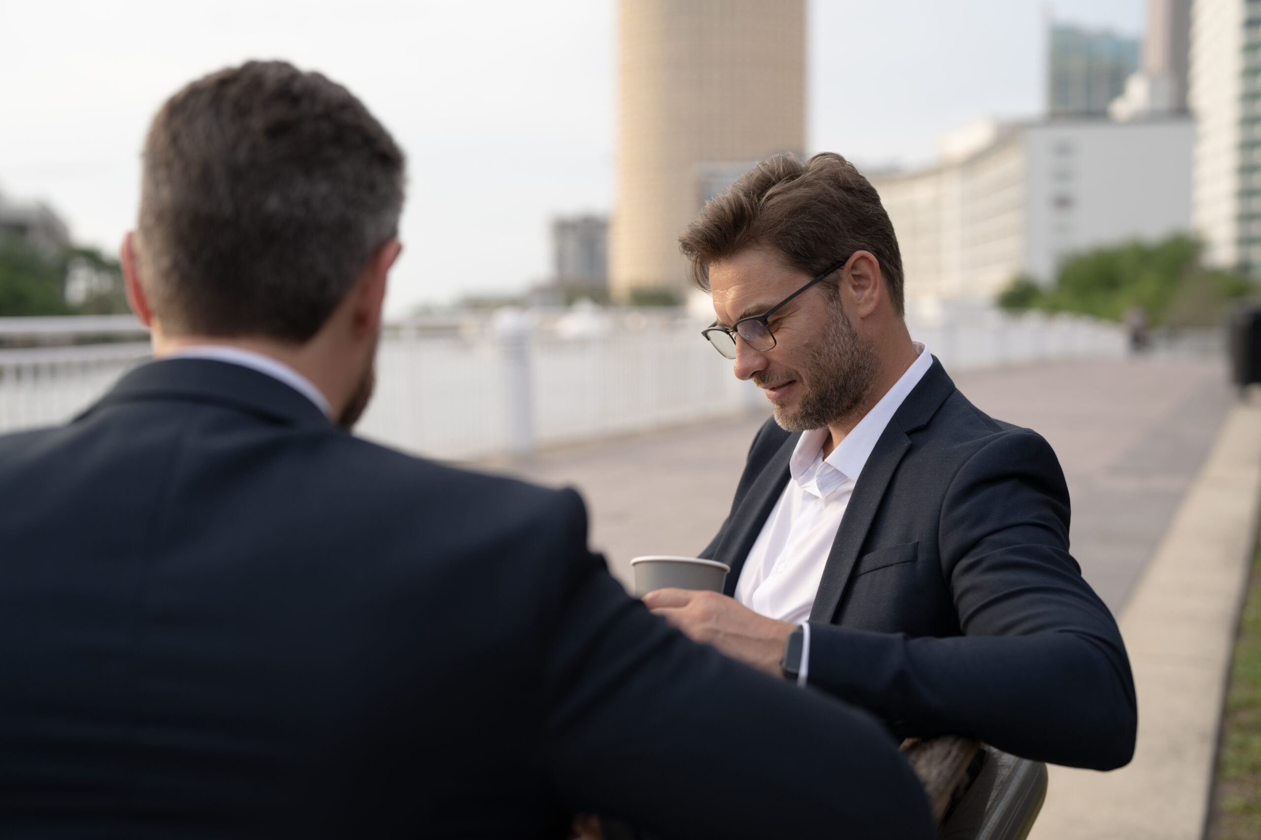 business meeting of two young businessmen in the city for a business lunch